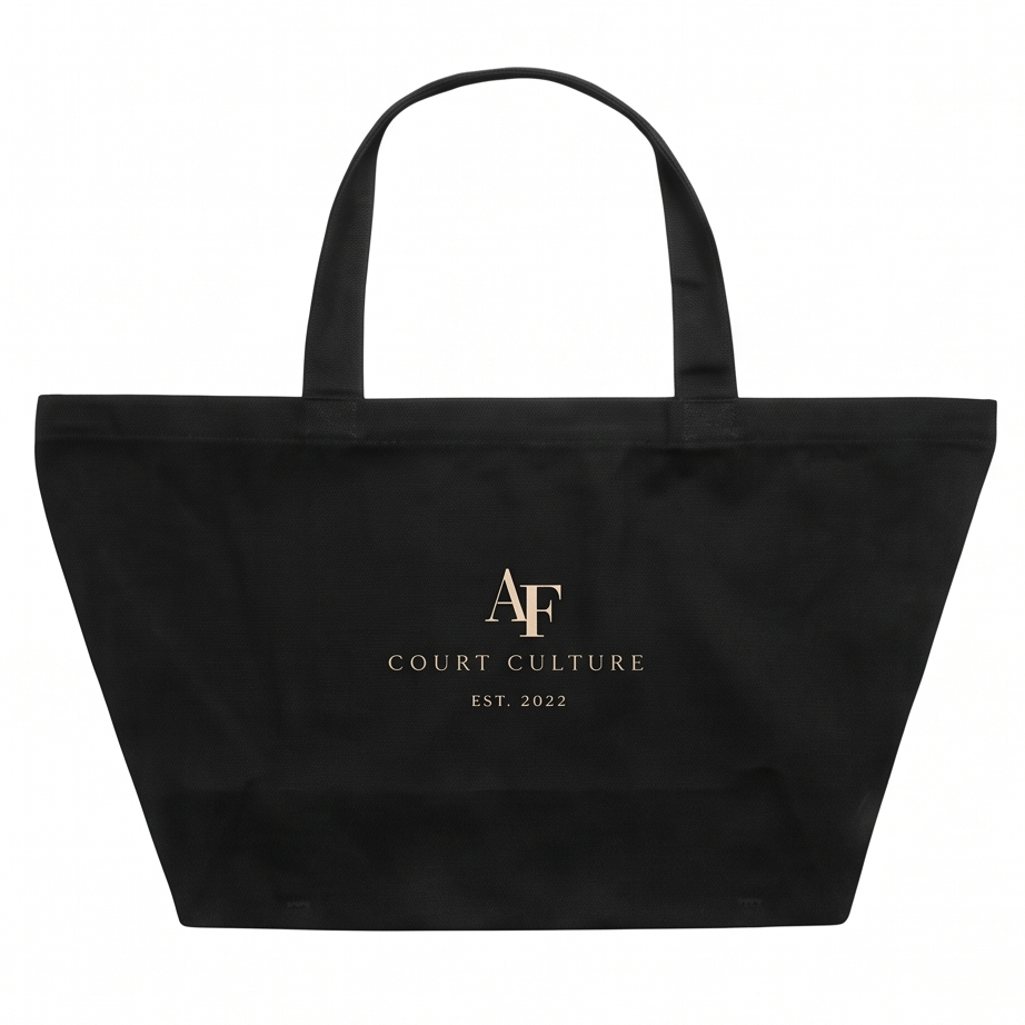 A black canvas tote bag with two top handles, featuring a gold foil logo and text that reads 'AF COURT CULTURE EST. 2022' on the front, set against a plain white background.