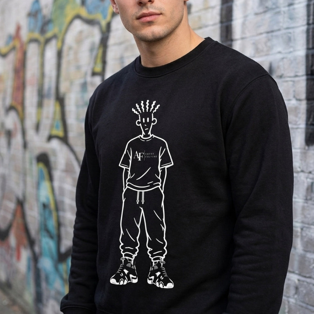 Man wearing a black sweatshirt with a white graphic design in front of a graffiti-covered wall.