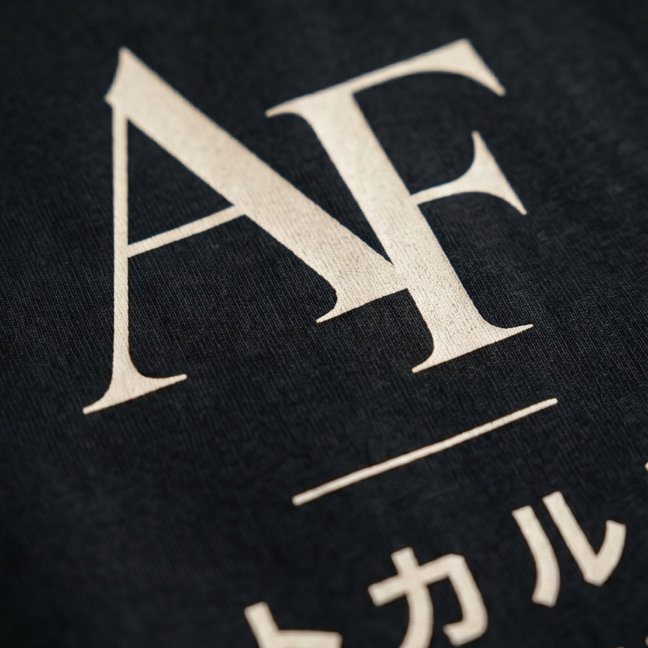 Close-up of a black fabric with white 'AF' and Japanese text.
