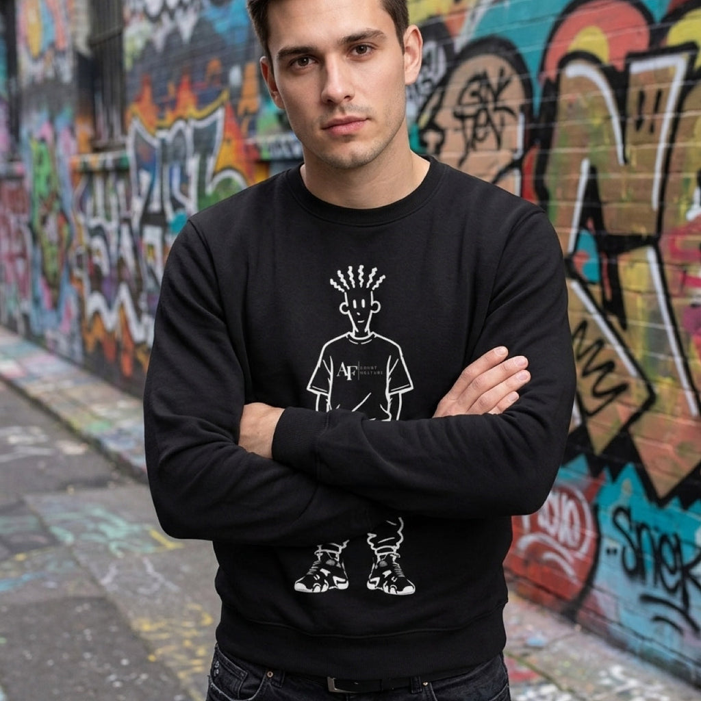 Man wearing a black sweatshirt with white graphics in front of a graffiti-covered wall.