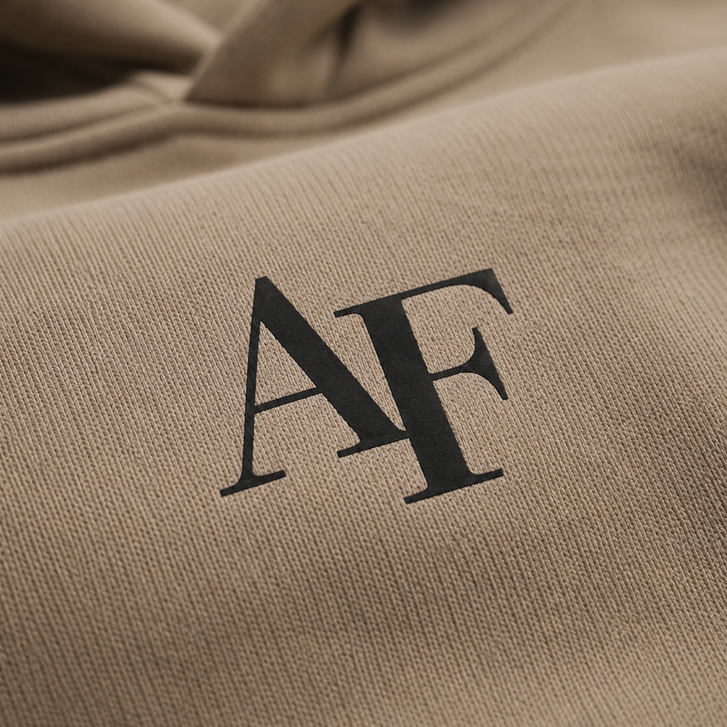 Close-up of a beige fabric with 'AF' initials embroidered on it.