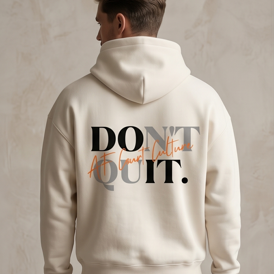 Person wearing a beige hoodie with 'DON'T QUIT. ACT. COUNT. WIN.' text on the back against a neutral background