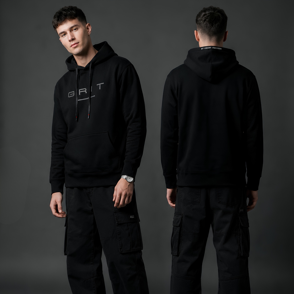 Person wearing a black hoodie with 'GRT' logo, standing against a gray background