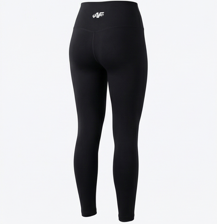 Black leggings with a logo on the waistband against a white background