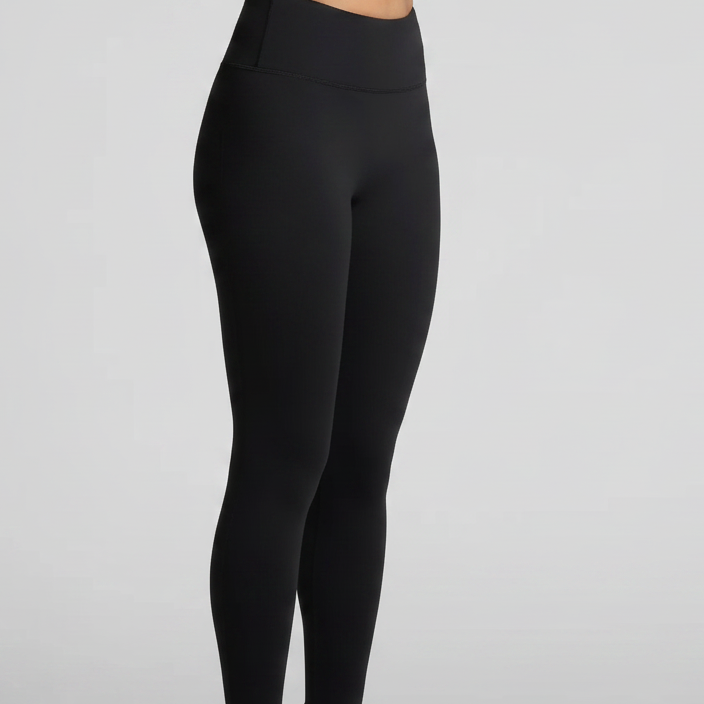 Black leggings worn by a person on a light gray background