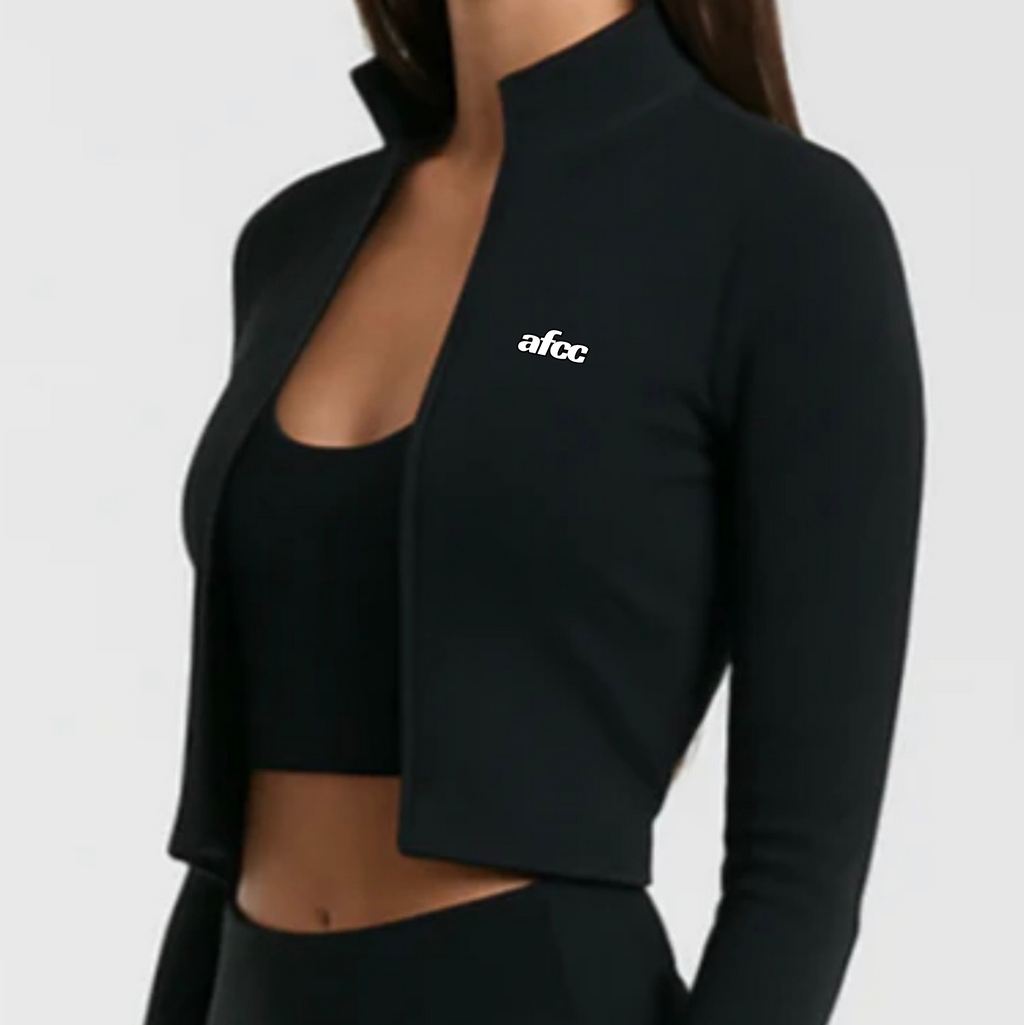 Black athletic outfit with a cropped jacket and leggings on a plain background