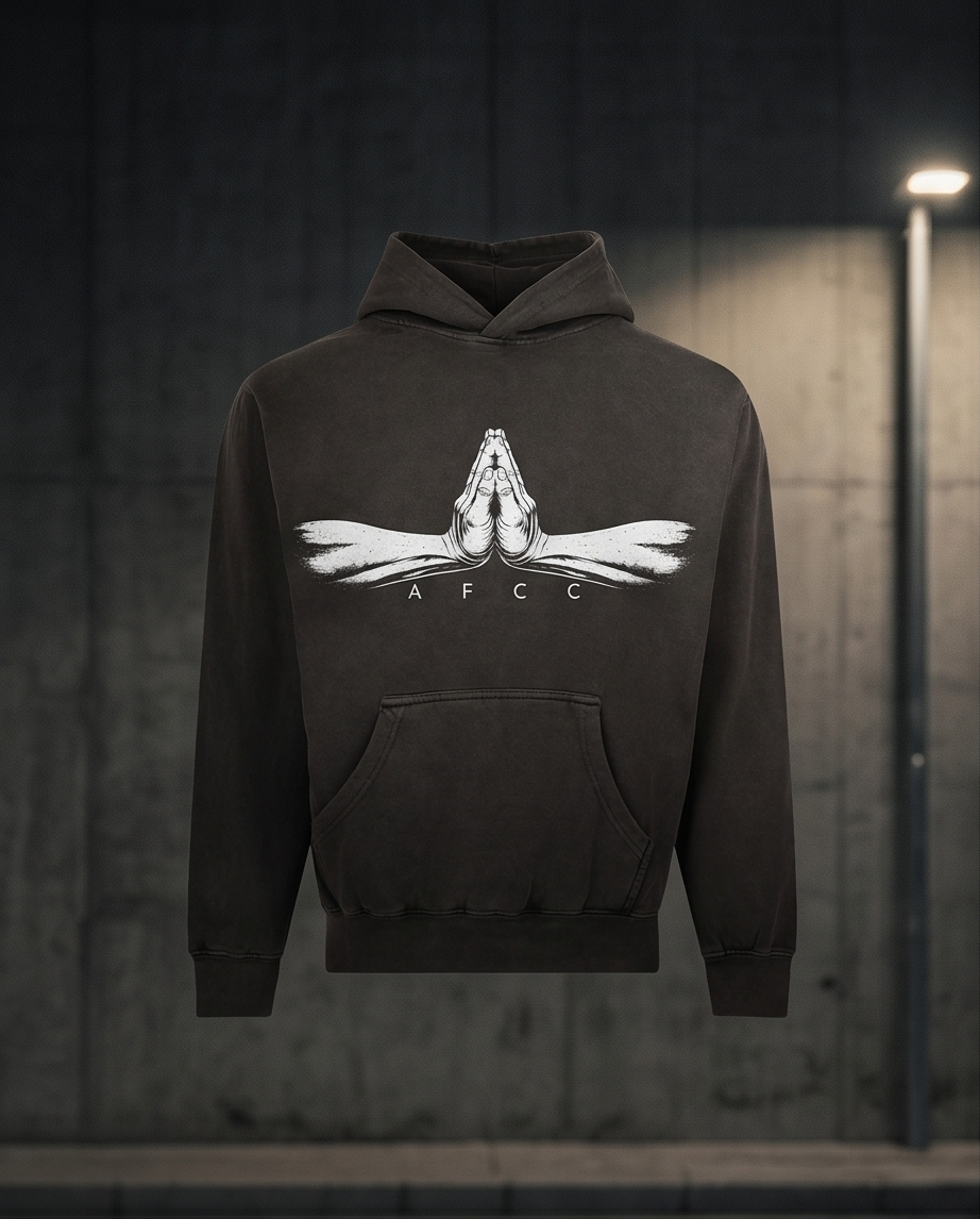 Black hoodie with a white logo on a dark background