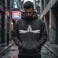 Man wearing a hoodie with a logo on a city street