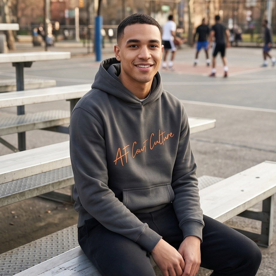 Person wearing a hoodie with 'AFC' branding sitting on a bench outdoors.