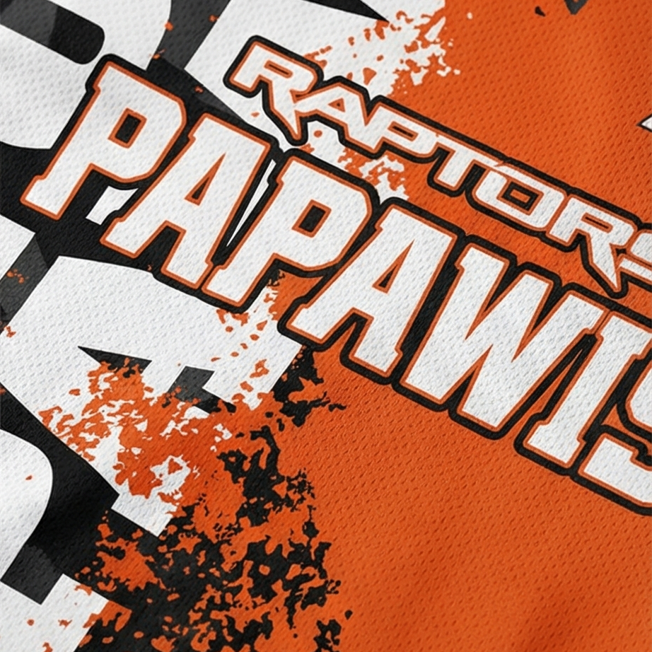 Close-up of a sports jersey with 'Raptors Papawis' text on an orange background