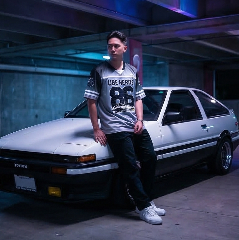 Person leaning against a white car in a dimly lit parking garage