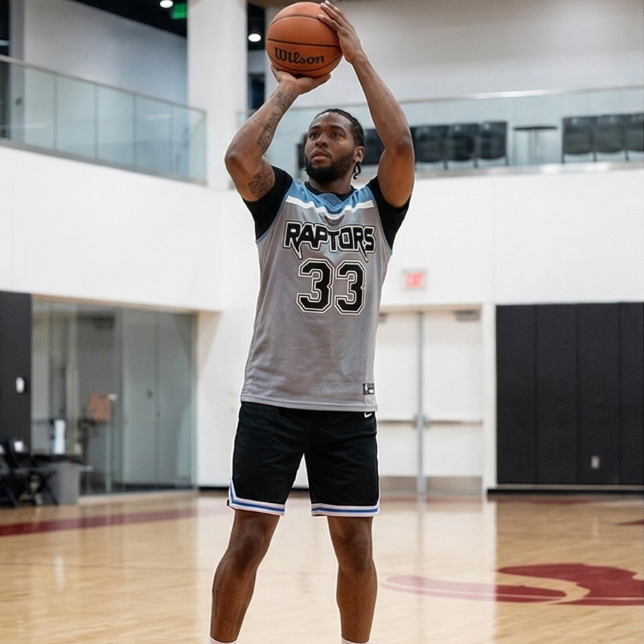 Person wearing a Raptors jersey holding a basketball on a court