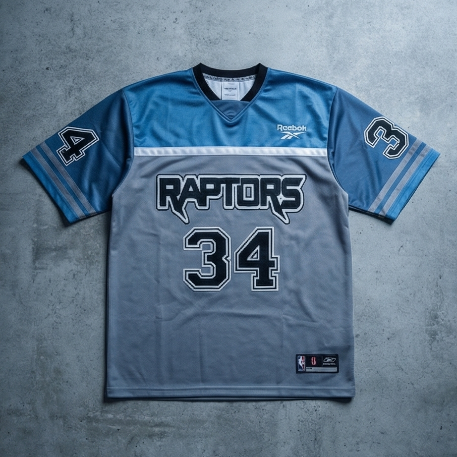 Blue sports jersey with 'Raptors' and number '34' on a gray background